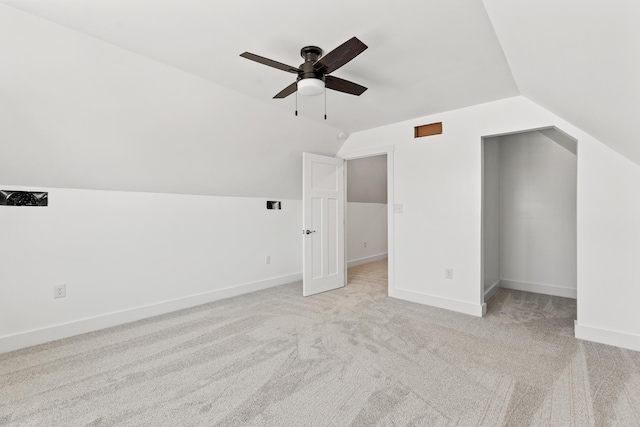 additional living space with ceiling fan, lofted ceiling, and light carpet