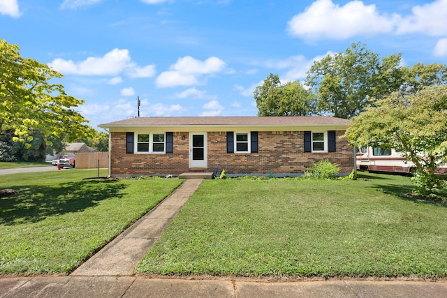 single story home featuring a front lawn