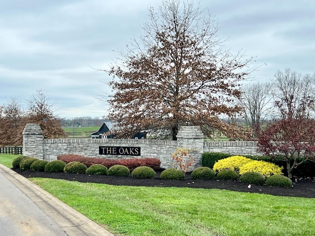 community / neighborhood sign with a lawn