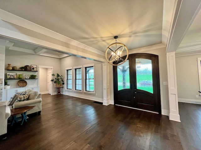 foyer entrance featuring a chandelier, a healthy amount of sunlight, and dark hardwood / wood-style floors