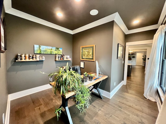 office with hardwood / wood-style floors and crown molding