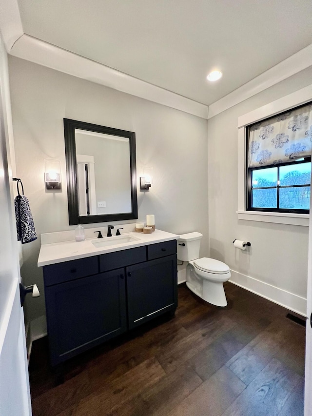 bathroom with vanity, hardwood / wood-style flooring, and toilet