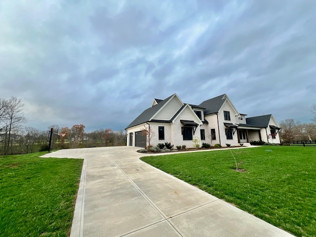 view of front of home featuring a garage and a front lawn