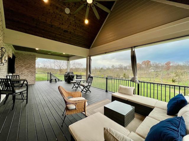 deck with a lawn, ceiling fan, a gazebo, and an outdoor hangout area