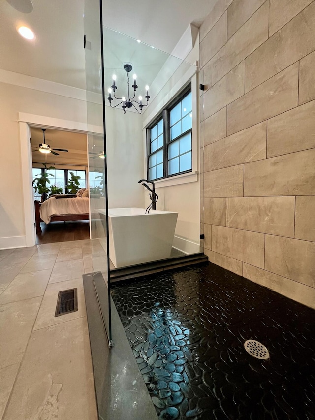 bathroom with independent shower and bath and an inviting chandelier