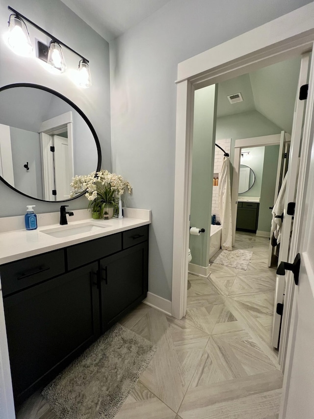 full bathroom featuring shower / bath combo, vanity, toilet, and vaulted ceiling