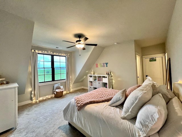 bedroom with carpet flooring, a textured ceiling, vaulted ceiling, and ceiling fan