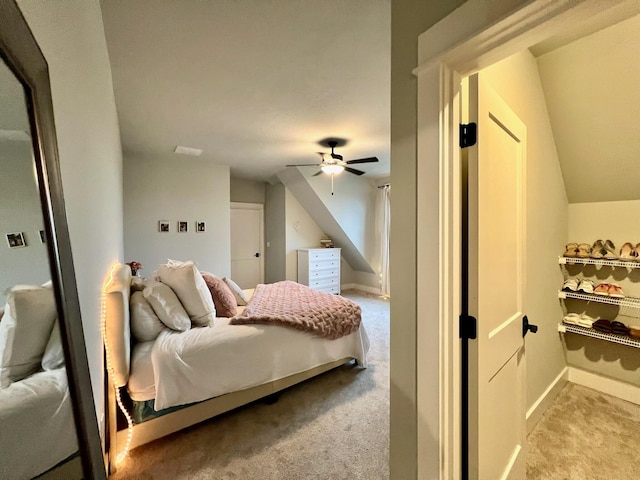 bedroom featuring ceiling fan, lofted ceiling, and light carpet