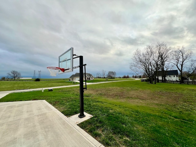 view of sport court with a yard