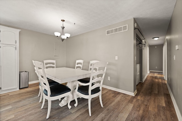 dining room featuring hardwood / wood-style flooring and a notable chandelier