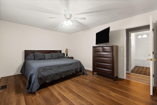 bedroom featuring a textured ceiling, ceiling fan with notable chandelier, and dark hardwood / wood-style floors