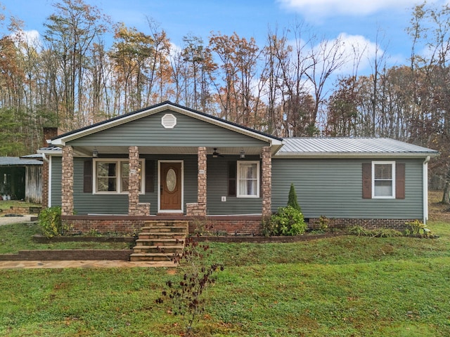 view of front of house with covered porch and a front lawn