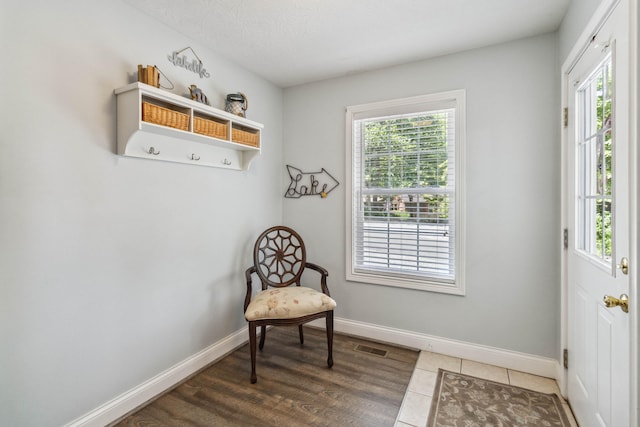 sitting room with a textured ceiling and dark hardwood / wood-style floors