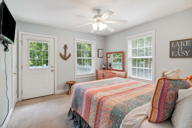 bedroom with ceiling fan and light carpet