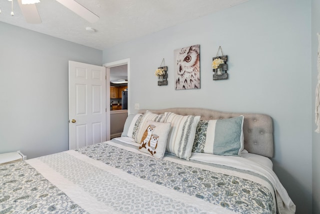 bedroom with a textured ceiling and ceiling fan