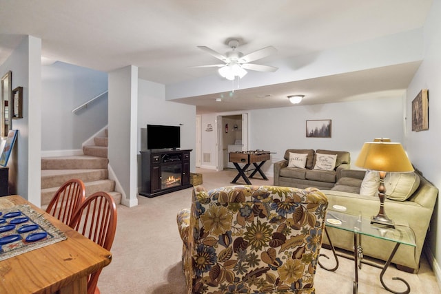 living room with light colored carpet and ceiling fan