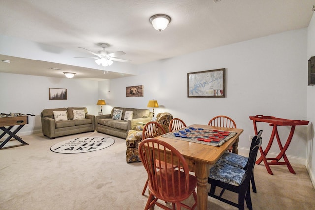 dining space with ceiling fan and carpet floors