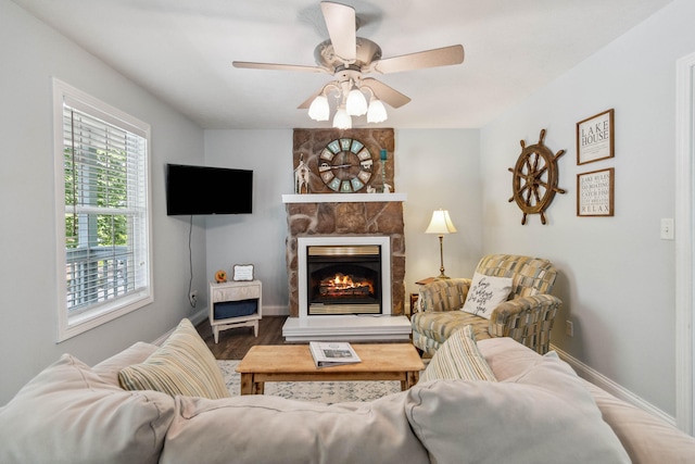 living room with ceiling fan, a fireplace, and hardwood / wood-style flooring