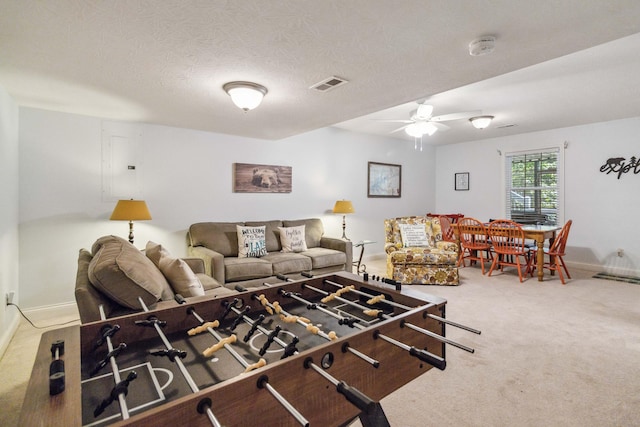 carpeted living room featuring a textured ceiling and ceiling fan