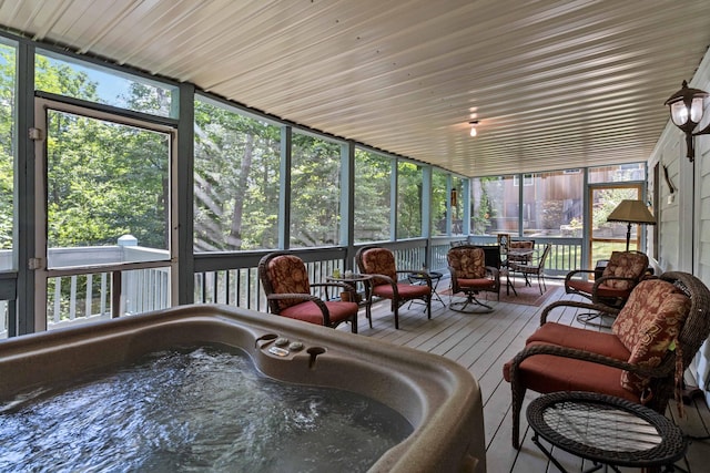 sunroom featuring a hot tub and sink