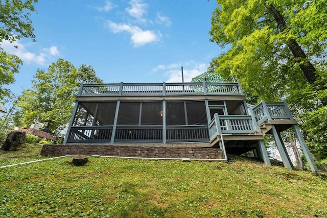 back of house with a lawn and a sunroom