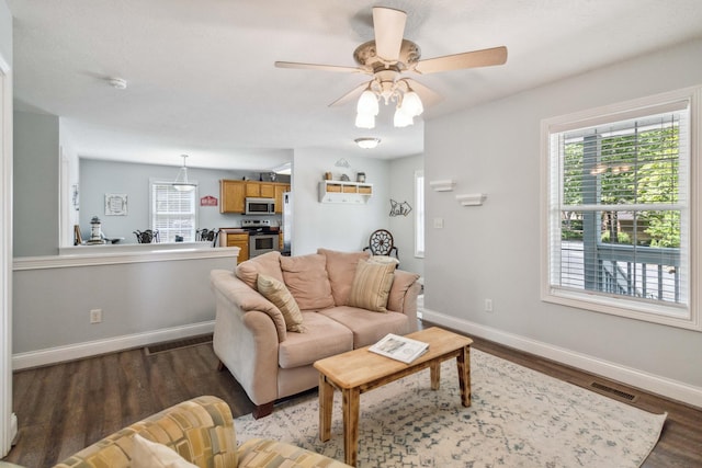 living room with hardwood / wood-style floors and ceiling fan