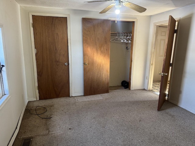 unfurnished bedroom with ceiling fan and light carpet