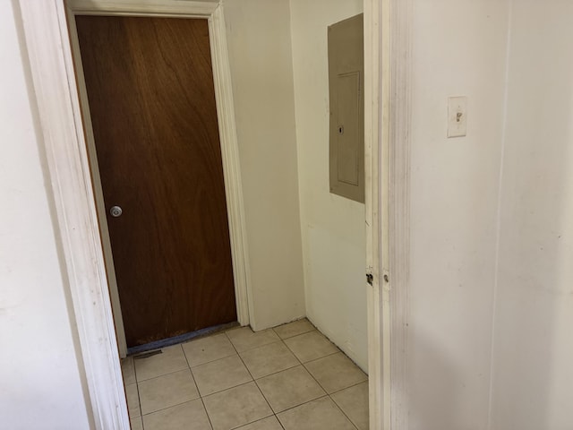 hallway with light tile patterned floors and electric panel