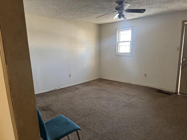 spare room with carpet, ceiling fan, and a textured ceiling