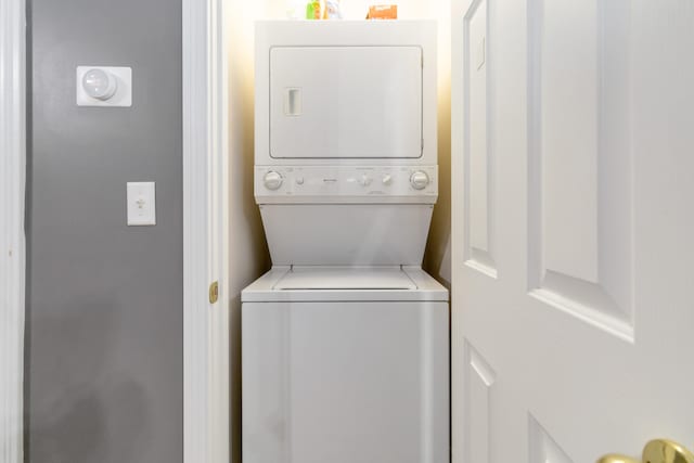 laundry area with stacked washer / dryer