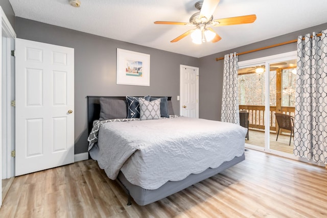 bedroom featuring wood-type flooring, access to outside, and ceiling fan