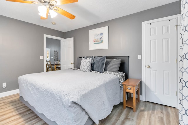 bedroom with wood-type flooring and ceiling fan