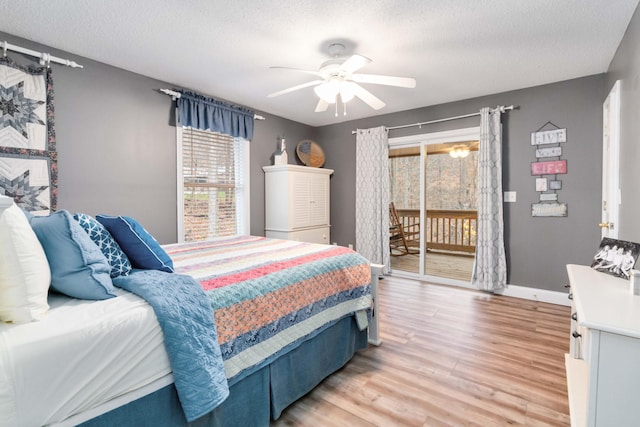 bedroom with access to exterior, wood-type flooring, a textured ceiling, and ceiling fan