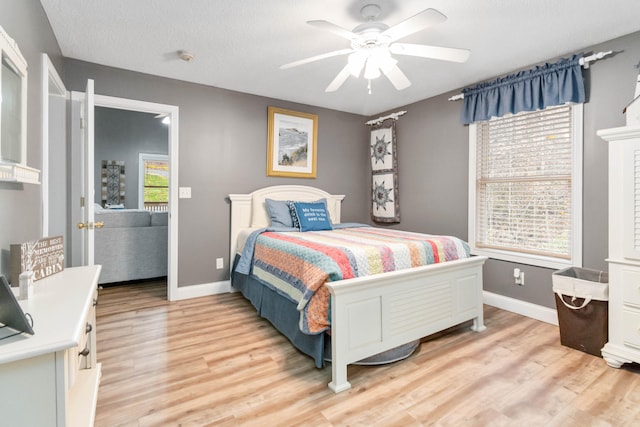 bedroom with light hardwood / wood-style floors, multiple windows, and ceiling fan