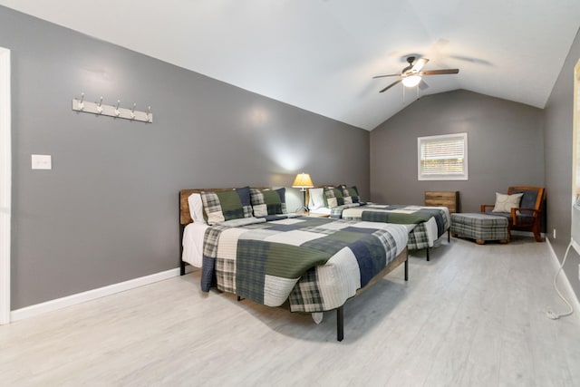 bedroom with ceiling fan, wood-type flooring, and lofted ceiling