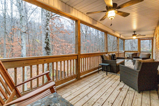 sunroom / solarium featuring a wealth of natural light, ceiling fan, and wood ceiling