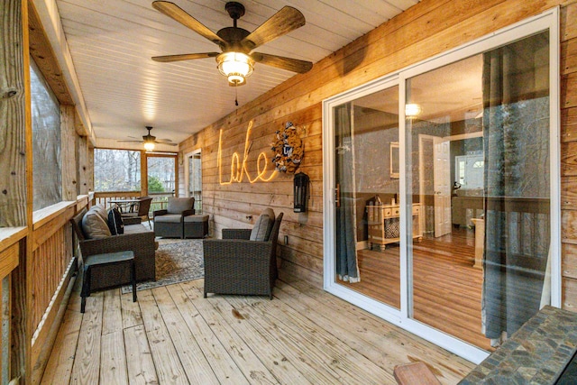 sunroom / solarium with ceiling fan and wood ceiling