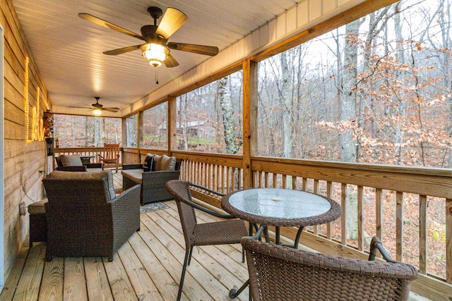 sunroom / solarium featuring a wealth of natural light, ceiling fan, and wooden ceiling