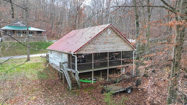 view of outdoor structure with a sunroom