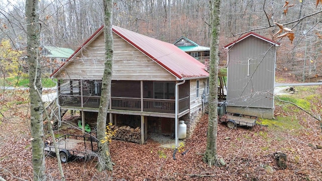 back of property with a sunroom