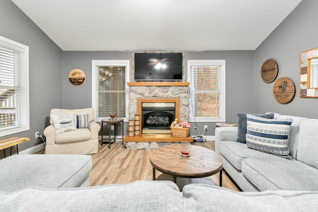 living room with hardwood / wood-style floors, lofted ceiling, and a wealth of natural light