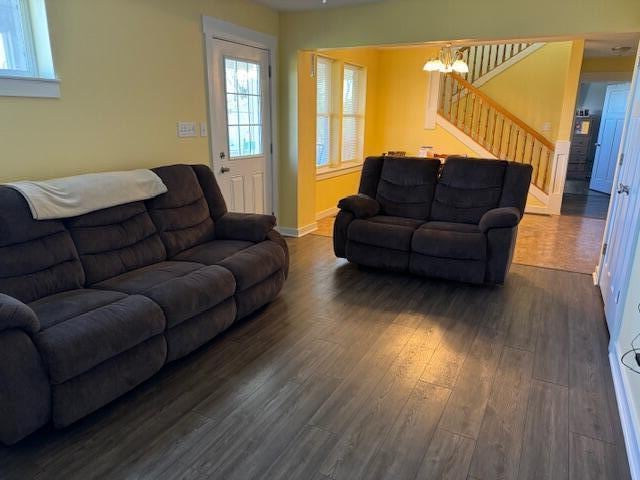 living room with dark hardwood / wood-style flooring