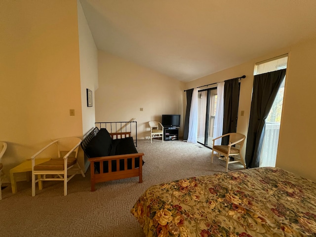 bedroom featuring carpet, lofted ceiling, and multiple windows