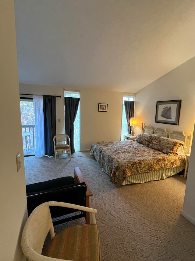 carpeted bedroom with access to outside and vaulted ceiling