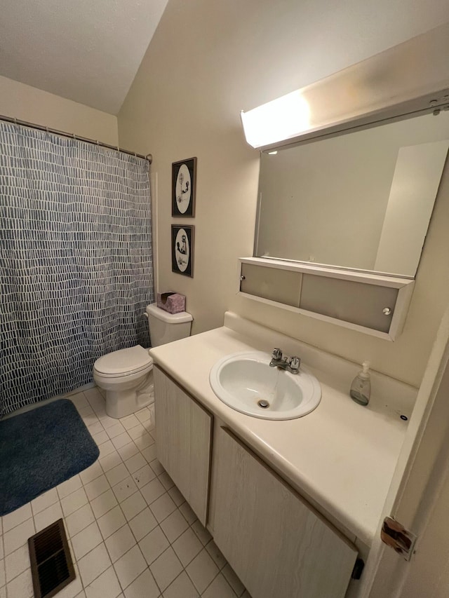 bathroom featuring tile patterned flooring, vanity, toilet, and curtained shower