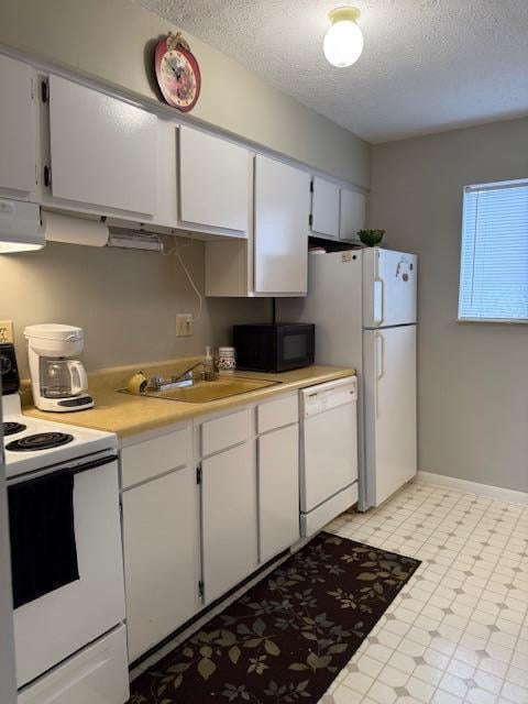 kitchen featuring a textured ceiling, white appliances, extractor fan, sink, and white cabinets