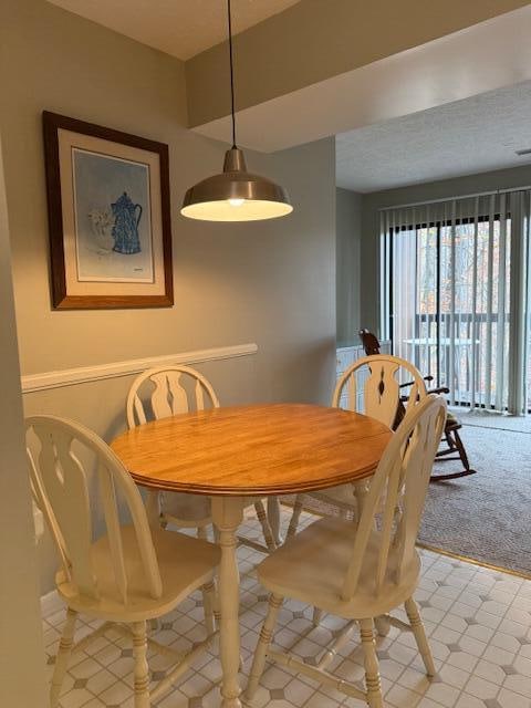 dining area with light colored carpet