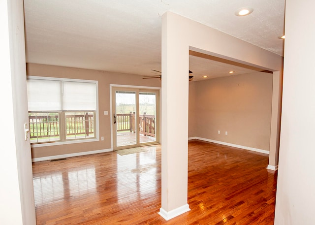 unfurnished room with ceiling fan and wood-type flooring