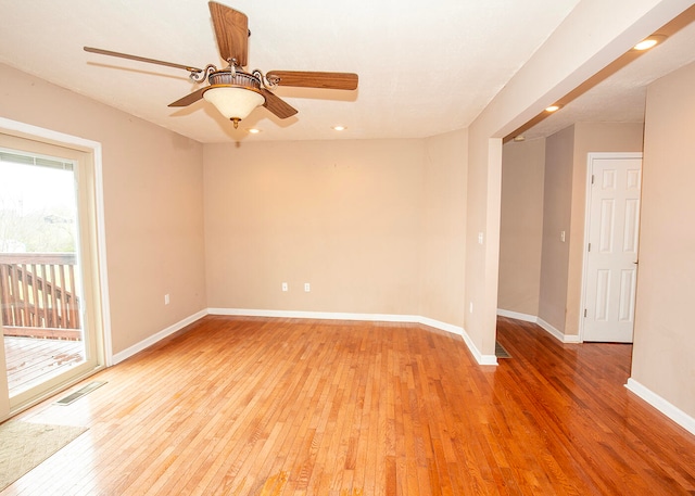 empty room with ceiling fan, a healthy amount of sunlight, and light hardwood / wood-style flooring