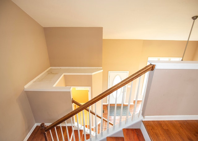 stairs with hardwood / wood-style flooring